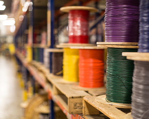 Warehouse shelf with colorfull wire spools